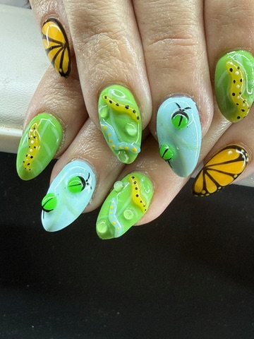 Colorful almond nails with caterpillars, butterflies and green fruit designs