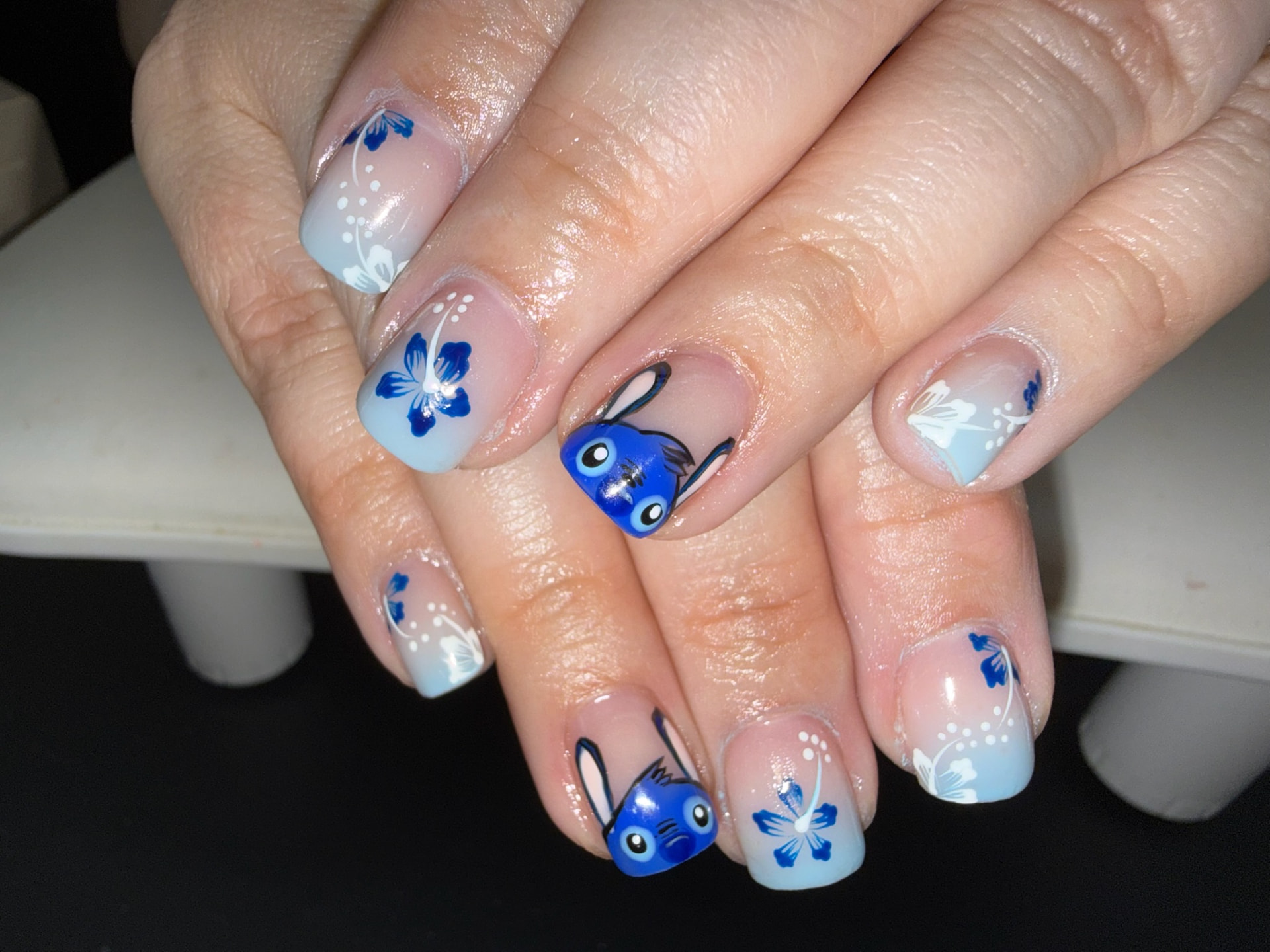 Short pale blue nails with blue flowers and hand-painted character art