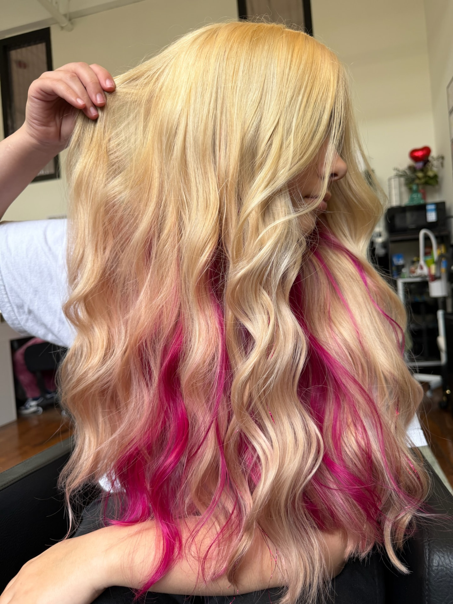 Long blonde waves with vivid pink underlights