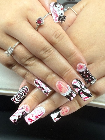 Long pink, black and white acrylic nails with graphic hand-painted art