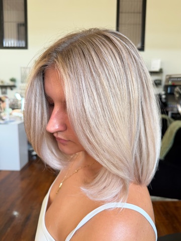 Icy blonde blunt bob styled smooth
